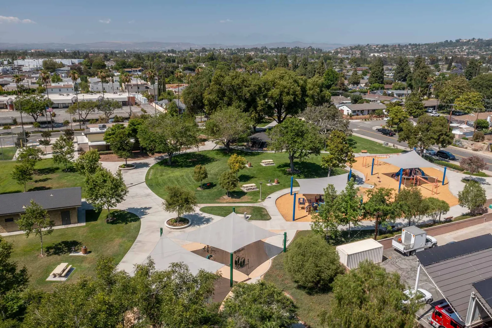 Aerial view of a nearby park with playground and shade structures