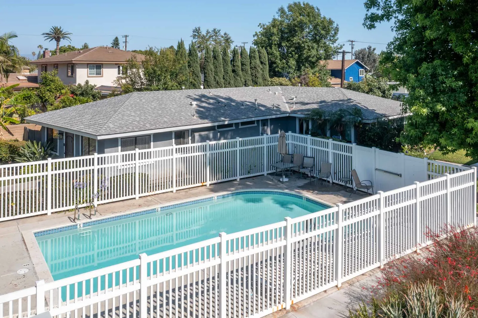 Community pool with the home behind it