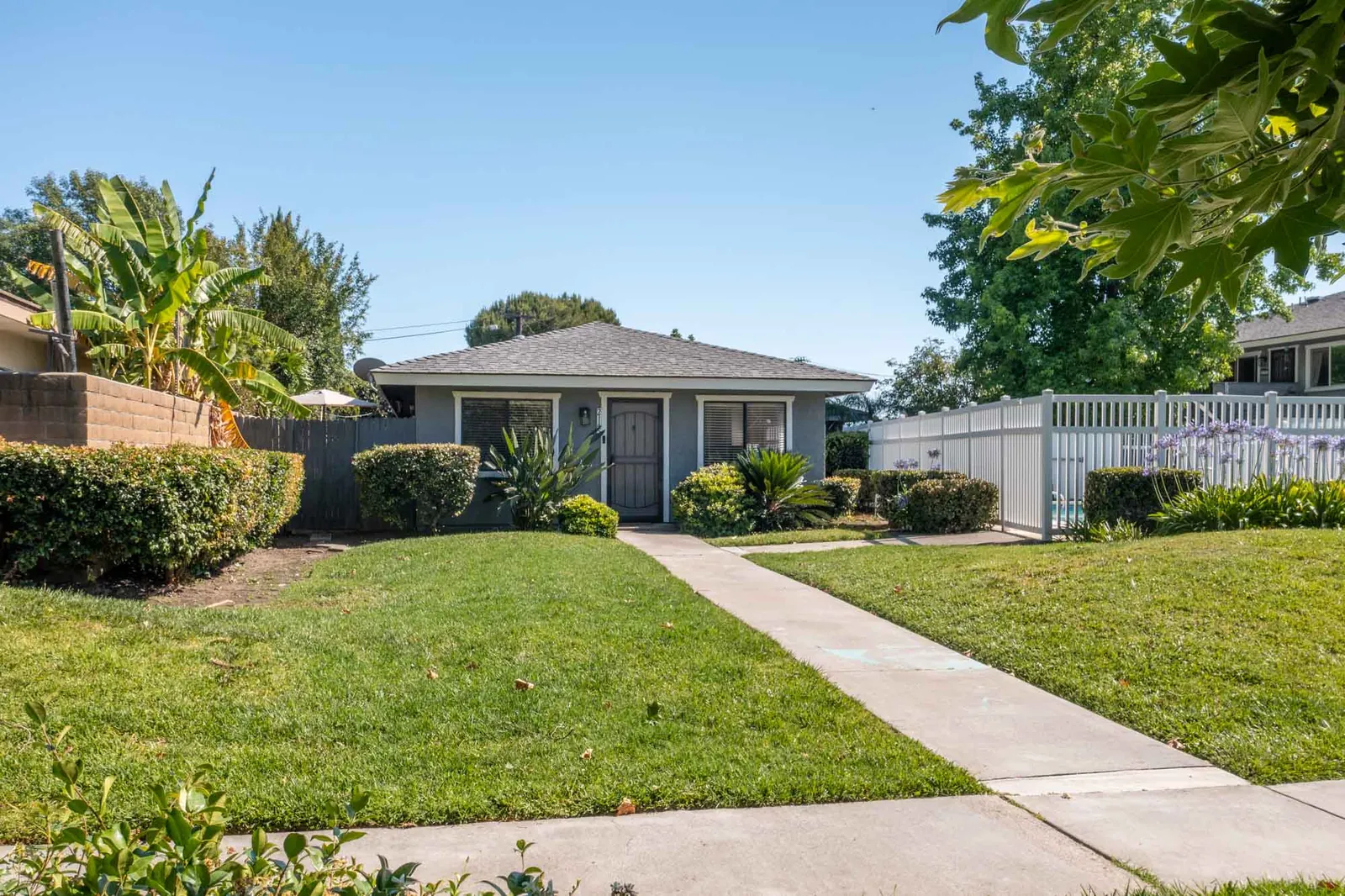 Front of the home across the greenbelt lawn